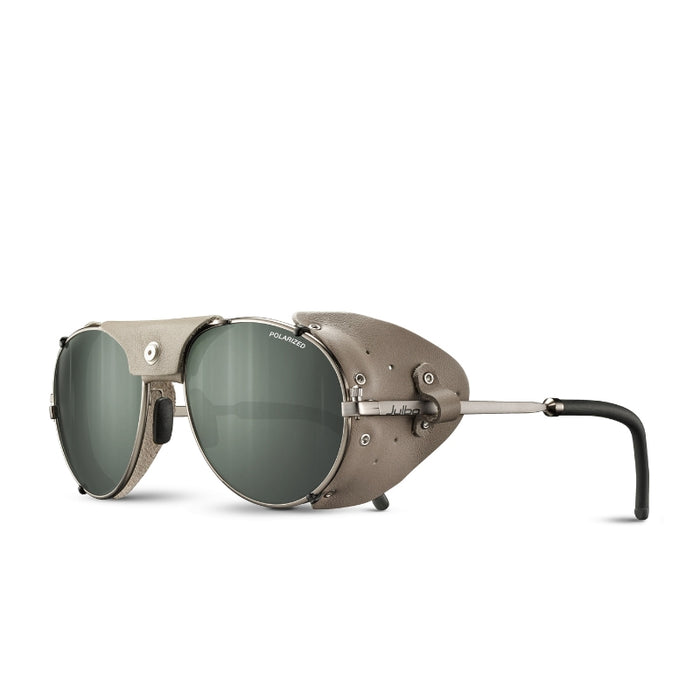 The Julbo-usa Cham sunglasses feature a matte silver mountaineering style with green lenses, side shields, a brow bar, and black curved temple tips—combining functional, industrial design inspired by alpine classics. #color_copper-natural-leather-with-spectron-3-polarized-lens