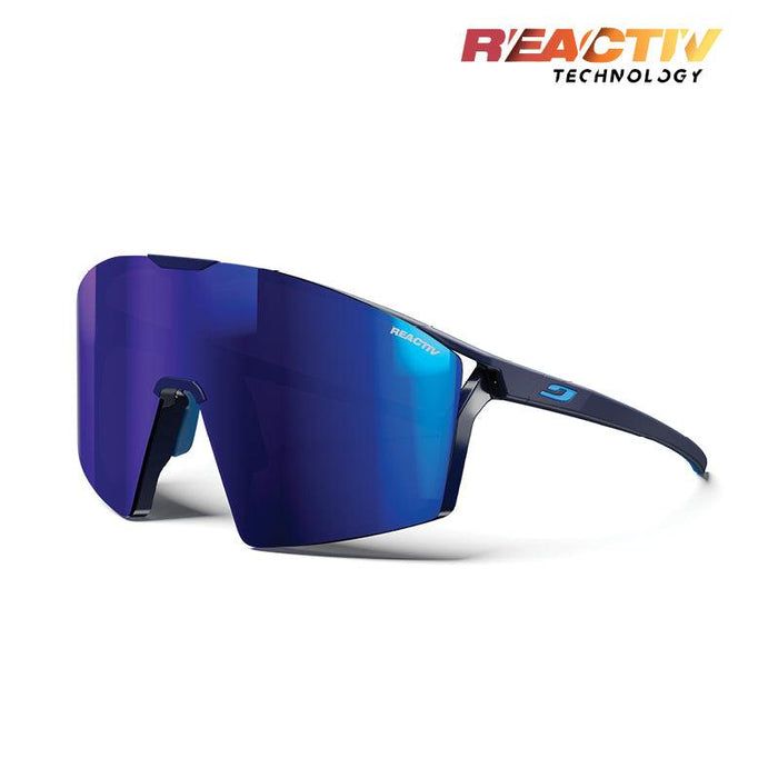 Julbo-usa Edge sunglasses feature a blue mirrored single shield lens, thin dark frame, REACTIV branding, and anti-fog coating for clear vision. The REACTIV Technology logo is displayed in the top right corner. #color_matte-blue-blue-with-reactiv-1-3-high-contrast-lens