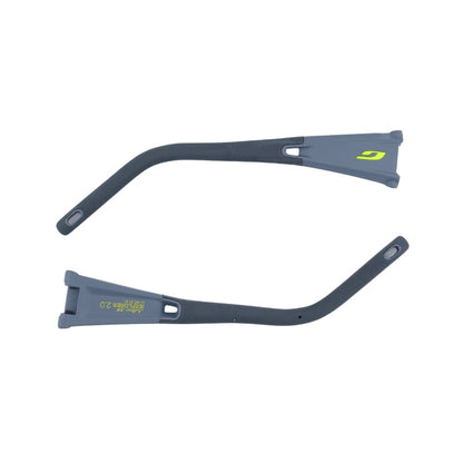 Two gray and black curved plastic parts with green accents—likely temple arms for Julbo USA Explorer 2.0 sunglasses—feature end loops and printed text, shown side by side on a white background.