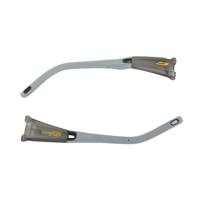 Two gray Julbo USA Explorer 2.0 replacement temple arms from the Lenses & Parts collection are shown on a white background, one with a yellow logo and the other with a small yellow marking.