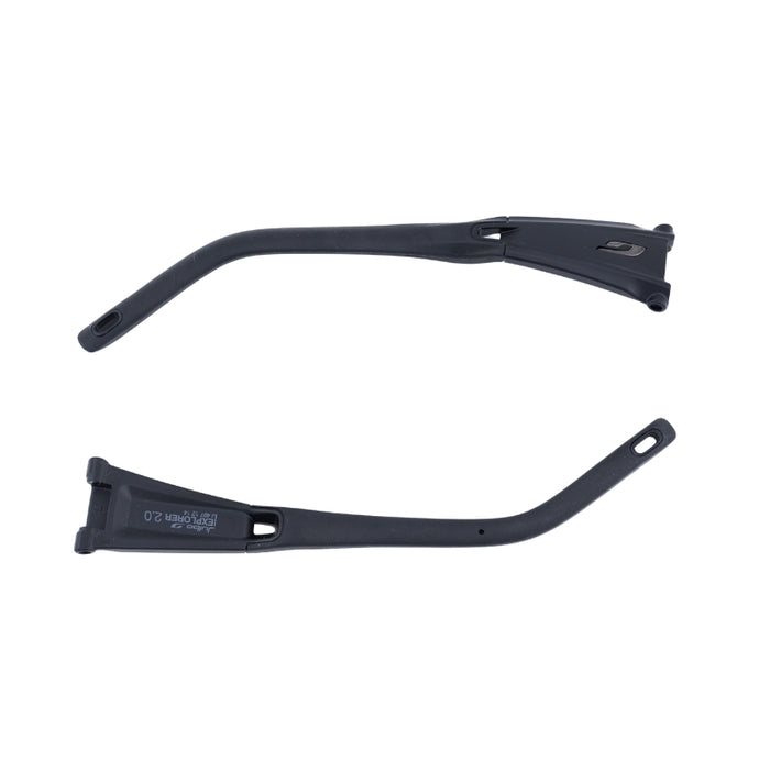 Two black plastic mudguard stays from Julbo USA's Explorer 2.0 Lenses & Parts are shown on a white background, featuring mounting holes at both ends and a design resembling the sleek temple arms of sunglasses.