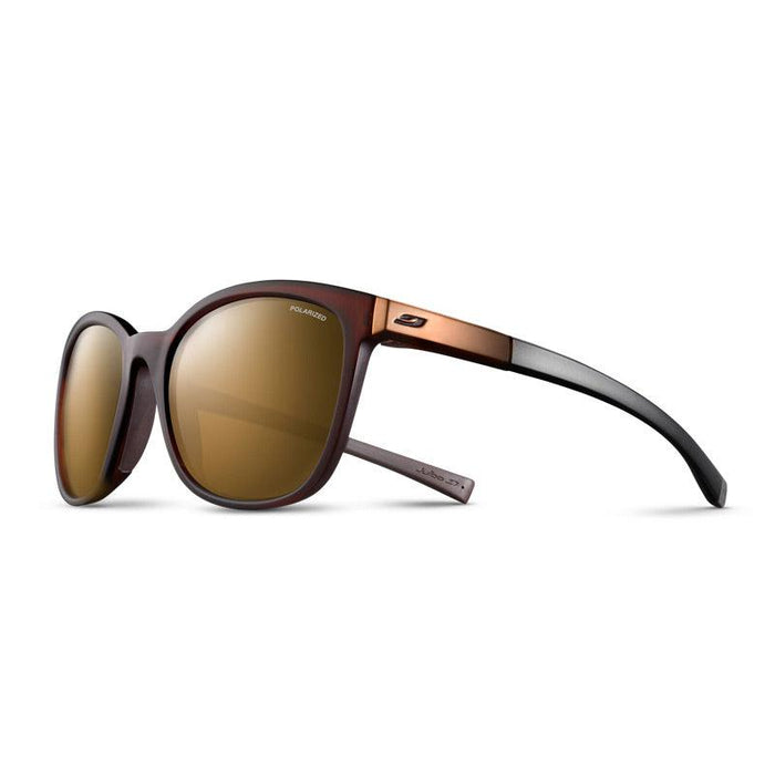 The Julbo-usa Spark women's sunglasses feature round, photochromic lenses with brown and black frames and a metallic brown temple accent, shown on a white background. #color_transluscent-brown-with-spectron-3-polarized-lens