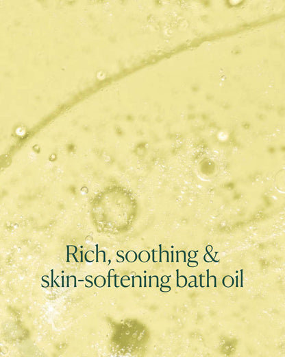 Close-up of milky bath oil texture in water with text emphasizing rich, soothing, skin-softening formula