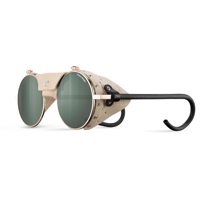 Julbo-usa Vermont Classic mountaineering glasses feature green high-performance lenses, beige leather side shields, metal rivets, and black curved temples, displayed on a white background. #color_rose-gold-beige-with-spectron-3-lens