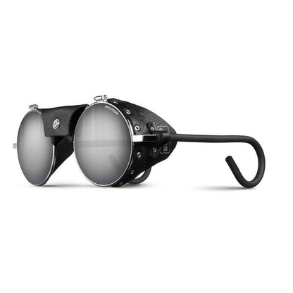The Julbo-usa Vermont Classic features round silver frames with side shields, black leather detailing, and curved black earpieces for a secure fit. High-performance lenses provide optimal eye protection for mountaineering. #color_chrome-black-with-spectron-4-lens