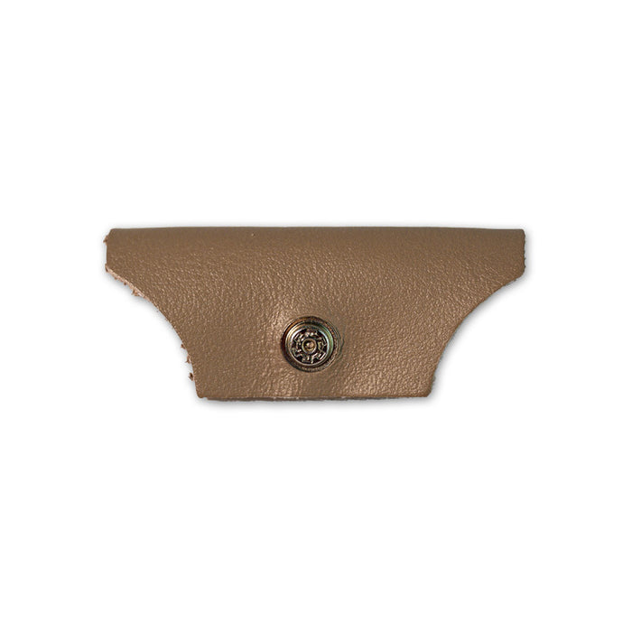 A tan, textured side shield with curved edges and a metal snap button, part of Julbo USA’s Vermont Lenses & Parts, designed for Vermont Classic sunglasses and shown on a white background. #color_vermont-nose-cover-brass