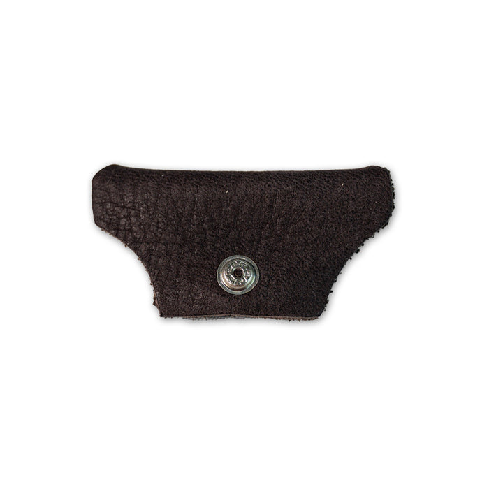 A small, textured dark brown leather piece with a metal snap button from Julbo USA’s Vermont Lenses & Parts, often used as side shields for Vermont Classic sunglasses, isolated on a white background. #color_vermont-nose-cover-copper-brown