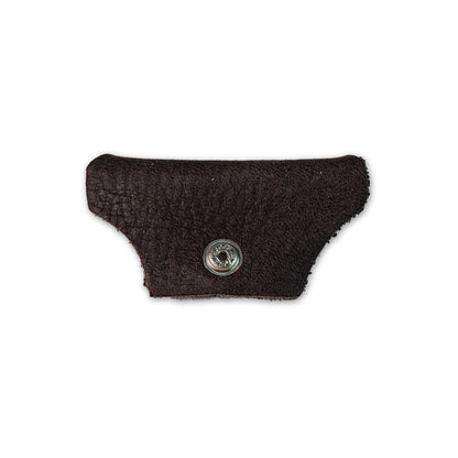 A small, textured dark brown leather piece with a metal snap button from Julbo USA’s Vermont Lenses & Parts, often used as side shields for Vermont Classic sunglasses, isolated on a white background. #color_vermont-nose-cover-copper-brown