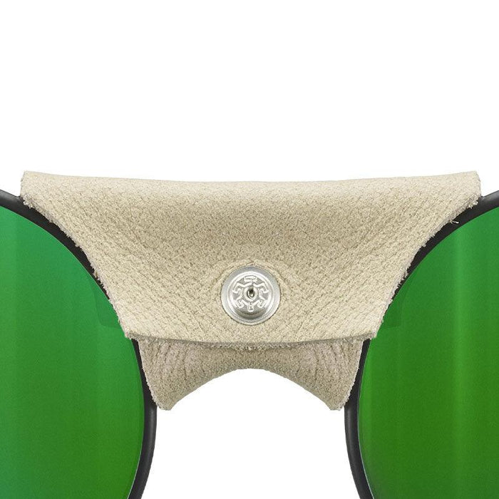 Close-up of Vermont Lenses & Parts by Julbo USA, featuring green lenses, a beige leather nose guard with silver button, and distinctive side shields—signature details of classic mountaineering sunglasses. #color_vermont-nose-cover-black-brown