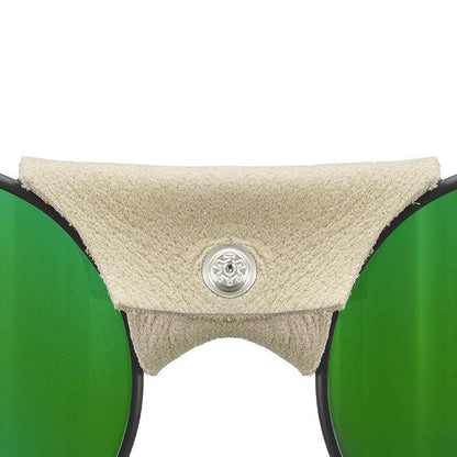 Close-up of Vermont Lenses & Parts by Julbo USA, featuring green lenses, a beige leather nose guard with silver button, and distinctive side shields—signature details of classic mountaineering sunglasses. #color_vermont-nose-cover-black-brown