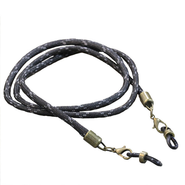 The Julbo Eyewear Vintage Sunglass Lanyard features a black and gray braided design with metal clips on both ends, providing a secure and stylish way to attach sunglasses or eyeglasses. #color_vintage-sunglass-lanyard-black-charcoal