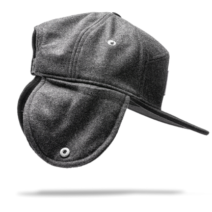 Stay warm in cold weather with the gray Julbo Eyewear Woodsman Hat, featuring a brim and cozy ear flaps. Inspired by classic designs, it's shown here against a white background with a subtle shadow underneath. #color_julbo-woodsman-hat-charcoal